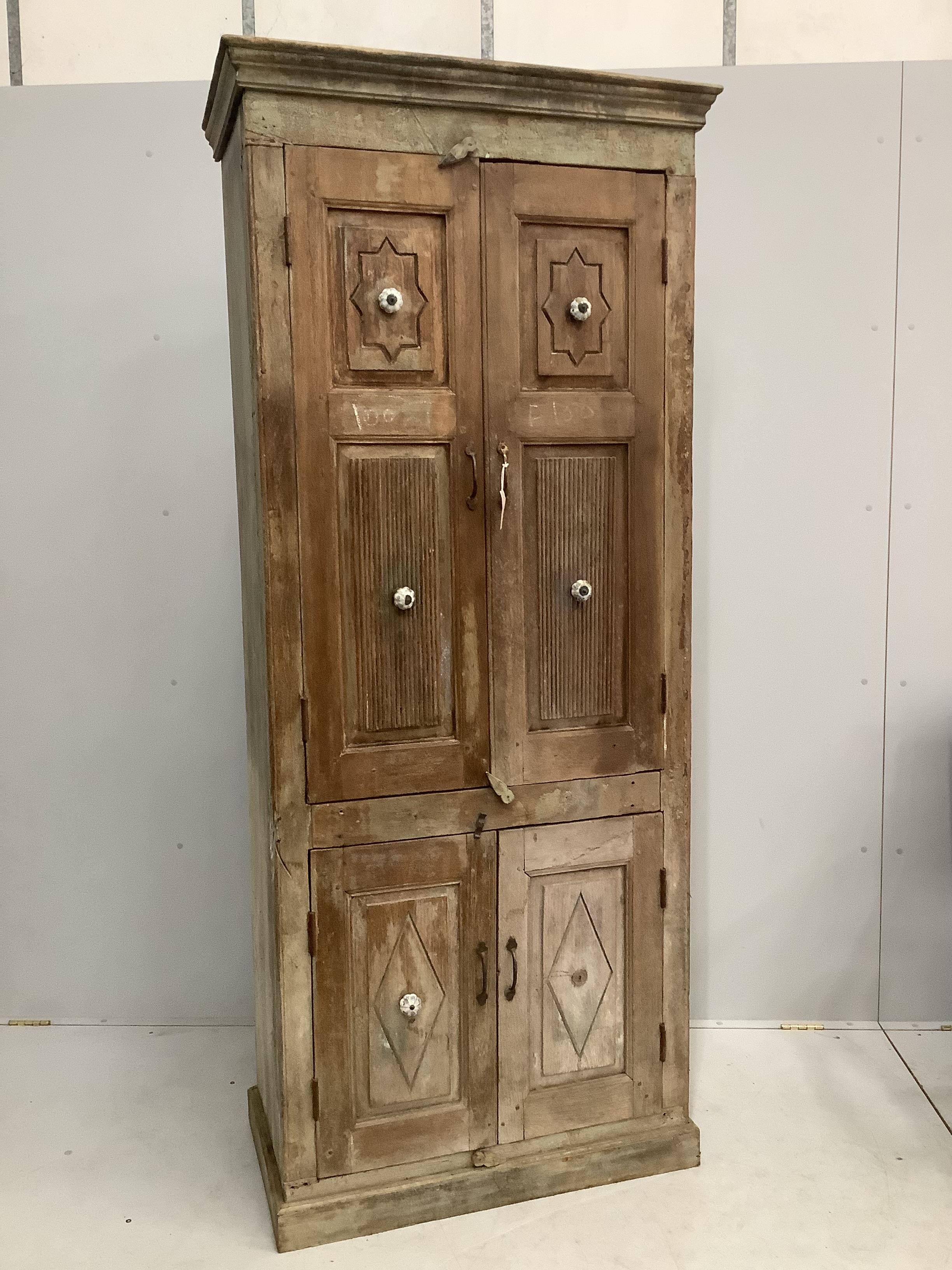 An Indian hardwood four door side cabinet, width 89cm, depth 48cm, height 210cm